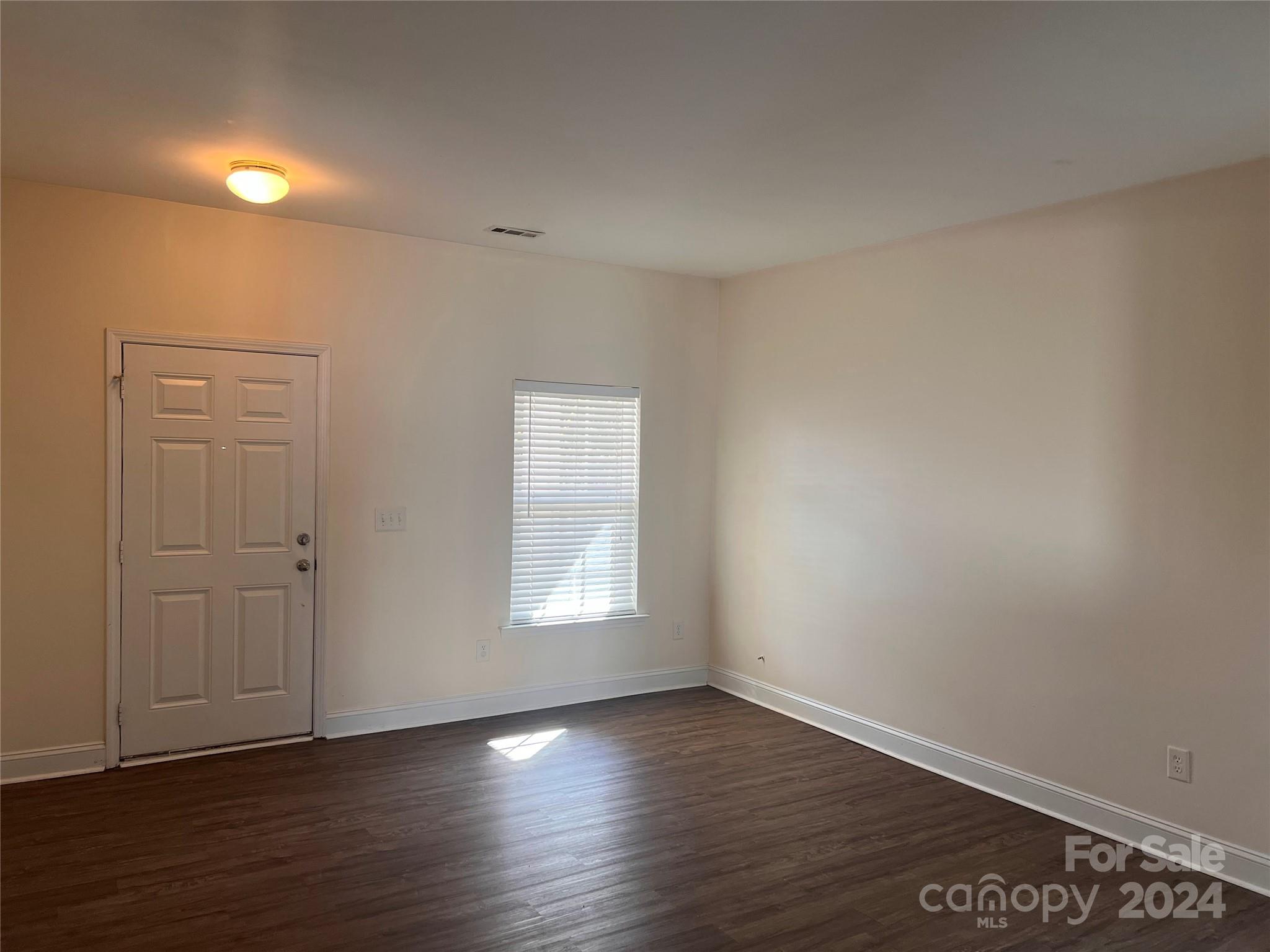 6706 Ferrell Commons Road Charlotte, NC 28269 - Photo 4 of 22 wooden floor in an empty room with a window