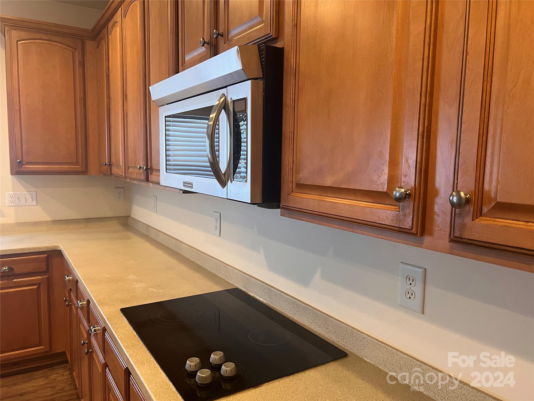 6706 Ferrell Commons Road Charlotte, NC 28269 - Photo 5 of 22 a kitchen with a sink a stove and a microwave oven