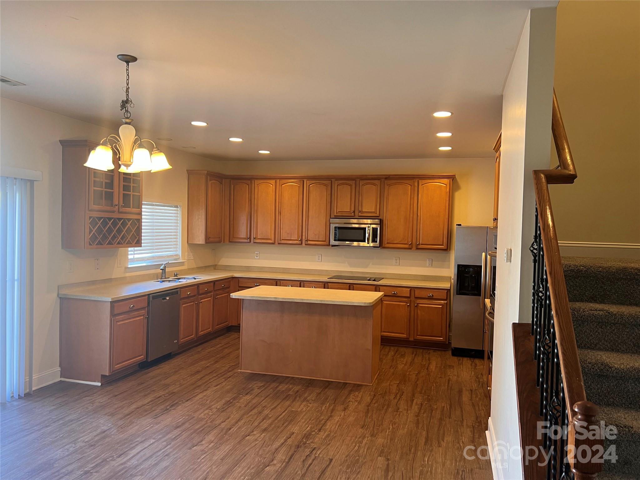 6706 Ferrell Commons Road Charlotte, NC 28269 - Photo 7 of 22 a large kitchen with lots of counter space a sink and appliances