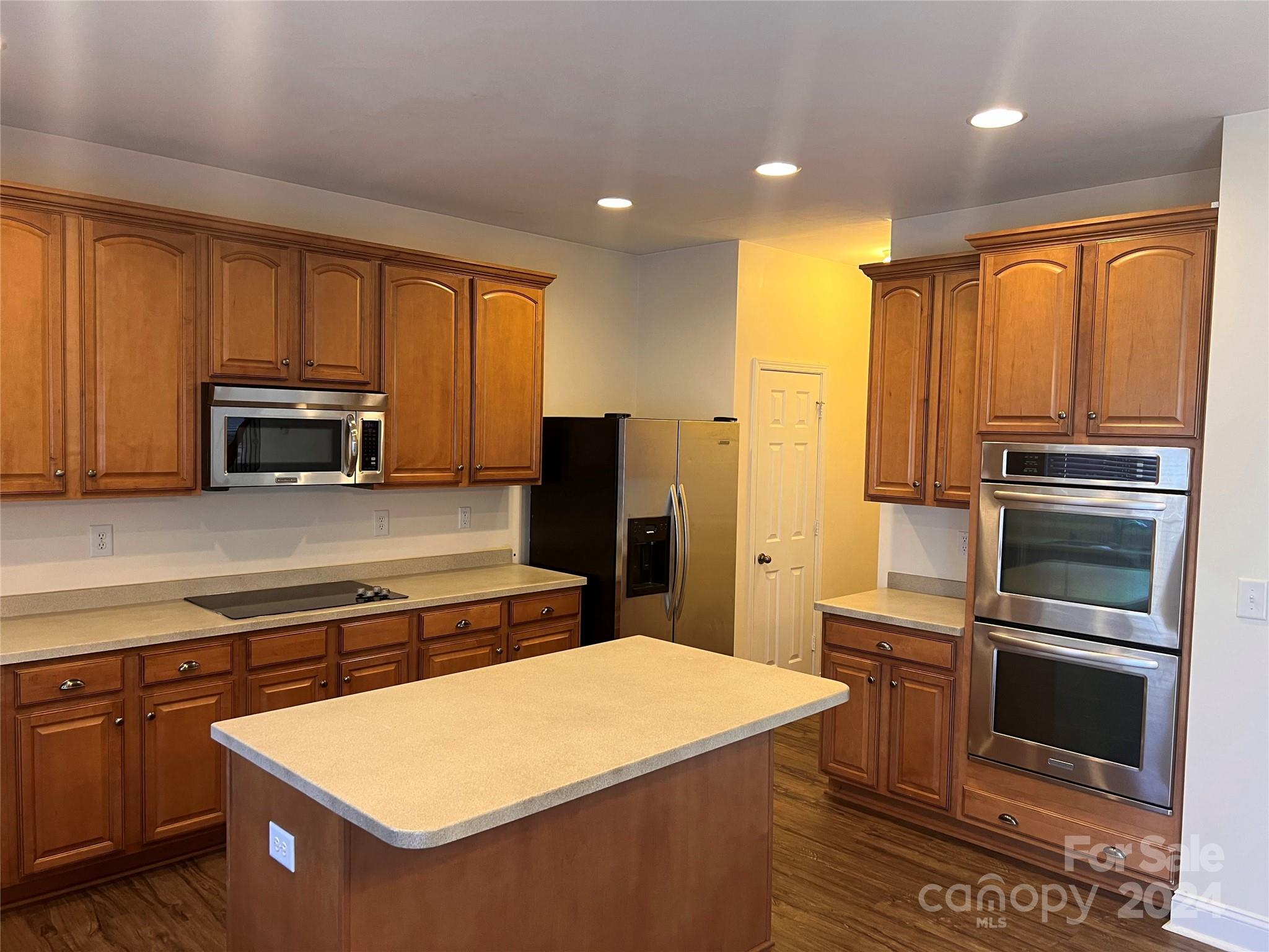 6706 Ferrell Commons Road Charlotte, NC 28269 - Photo 8 of 22 a kitchen with stainless steel appliances a stove sink and microwave