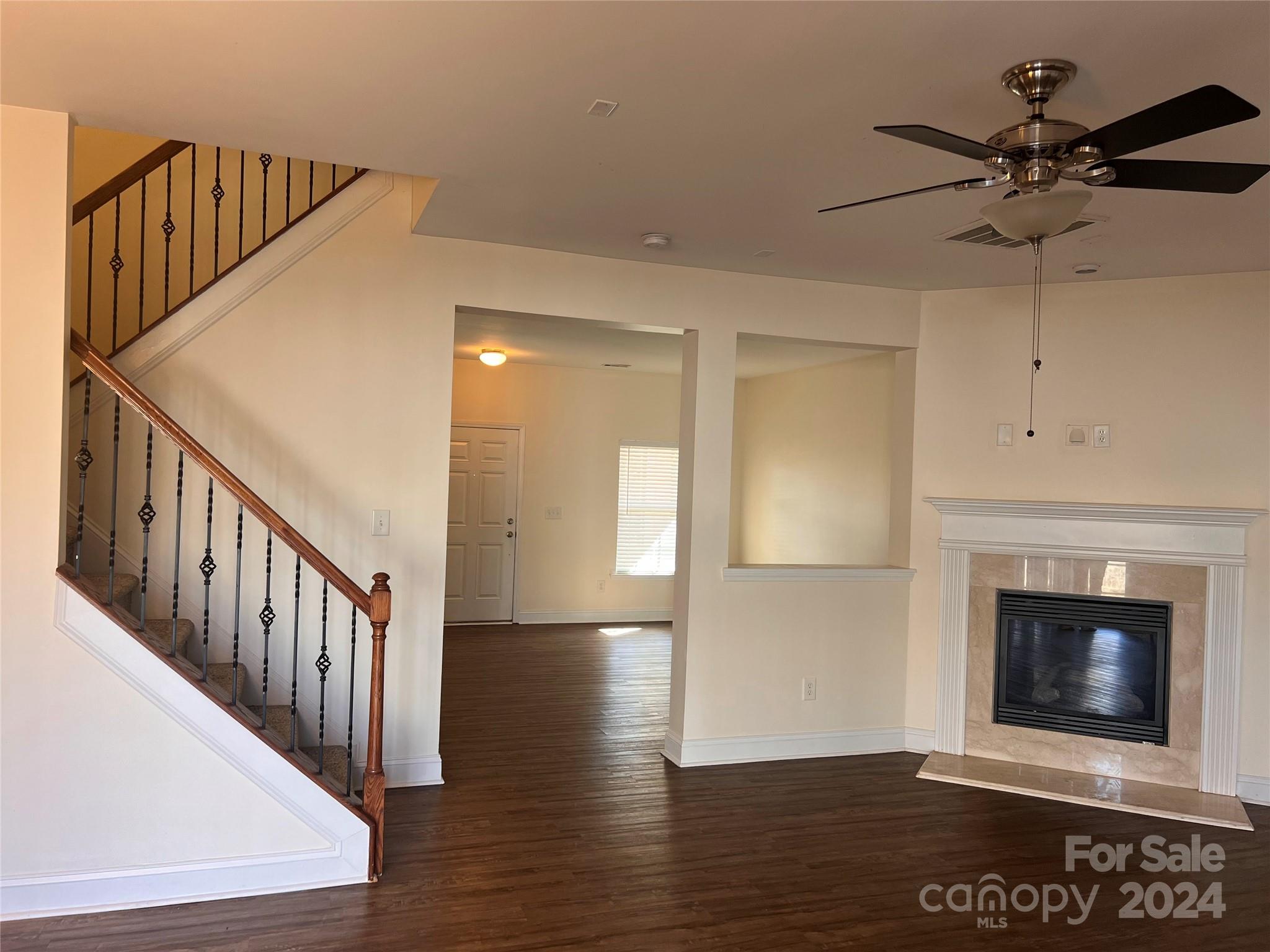 6706 Ferrell Commons Road Charlotte, NC 28269 - Photo 9 of 22 a view of an empty room wooden floor and a fireplace