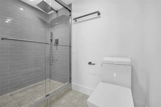 a bathroom with a shower and toilet