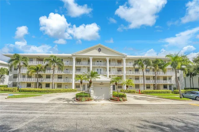 a front view of a building with a garden