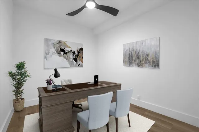 a view of a workspace with furniture and wooden floor