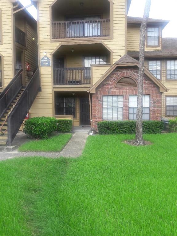 364 Northpointe Court, Unit 103 Altamonte Springs, FL 32701 - Photo 1 of 1 a front view of a house with a yard and garage