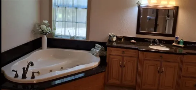 a bathroom with a bathtub and a sink