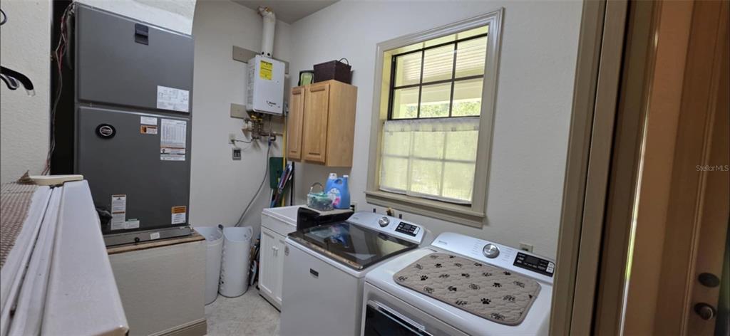 8991 Southwest Springhaven Avenue Indiantown, FL 34956 - Photo 17 of 30 a kitchen with stainless steel appliances a stove a refrigerator and a window