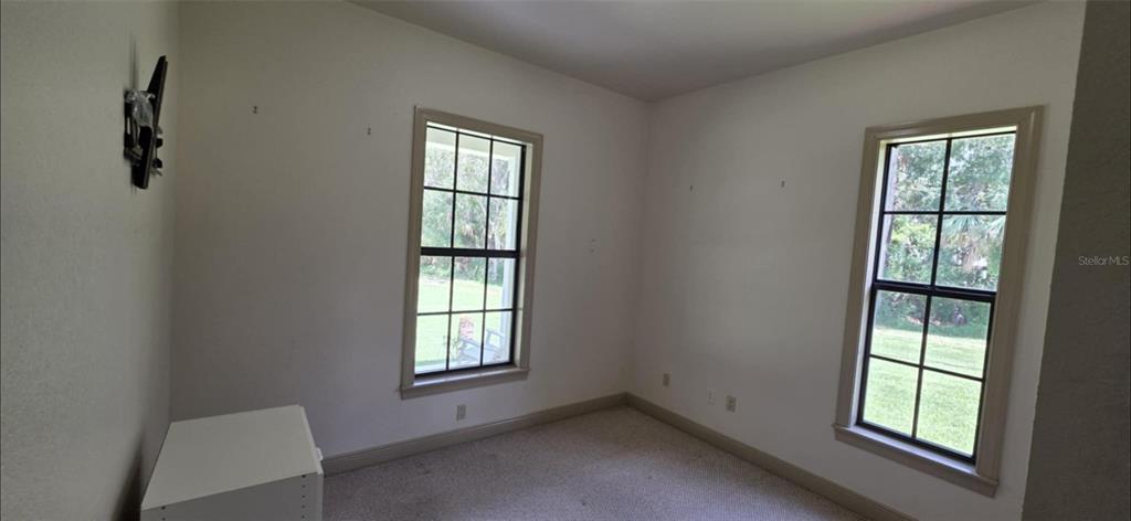 8991 Southwest Springhaven Avenue Indiantown, FL 34956 - Photo 19 of 30 an empty room with windows