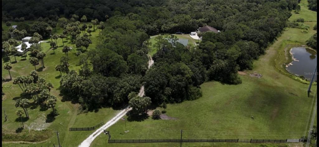 8991 Southwest Springhaven Avenue Indiantown, FL 34956 - Photo 2 of 30 an aerial view of residential house with outdoor space and trees all around