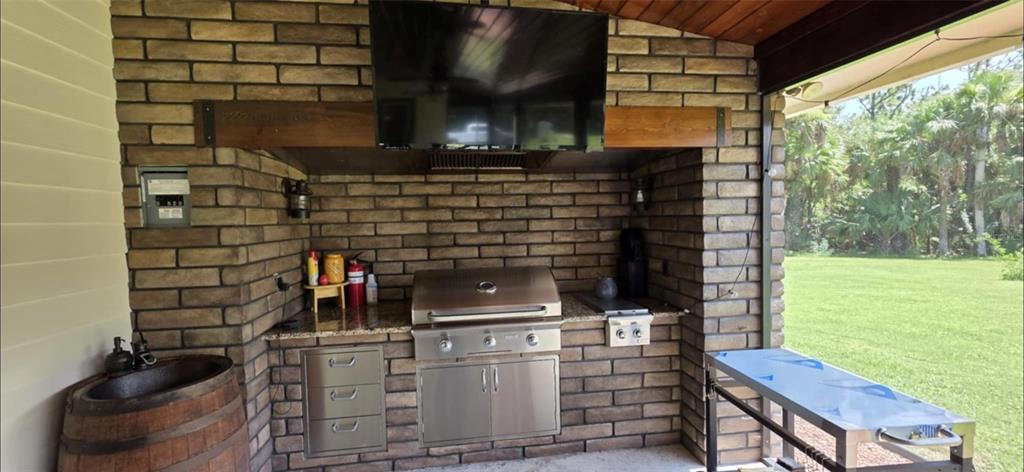 8991 Southwest Springhaven Avenue Indiantown, FL 34956 - Photo 25 of 30 a kitchen with a sink and a stove