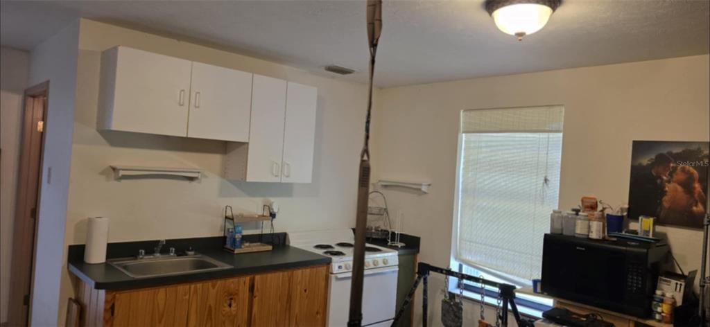 8991 Southwest Springhaven Avenue Indiantown, FL 34956 - Photo 30 of 30 a kitchen with a sink appliances and cabinets