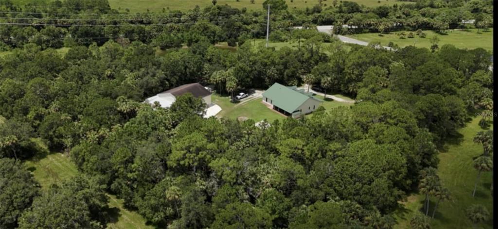8991 Southwest Springhaven Avenue Indiantown, FL 34956 - Photo 4 of 30 an aerial view of a house with a yard