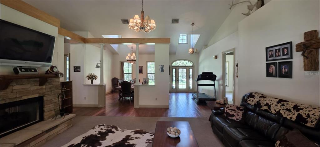 8991 Southwest Springhaven Avenue Indiantown, FL 34956 - Photo 5 of 30 a living room with furniture a flat screen tv and a fireplace