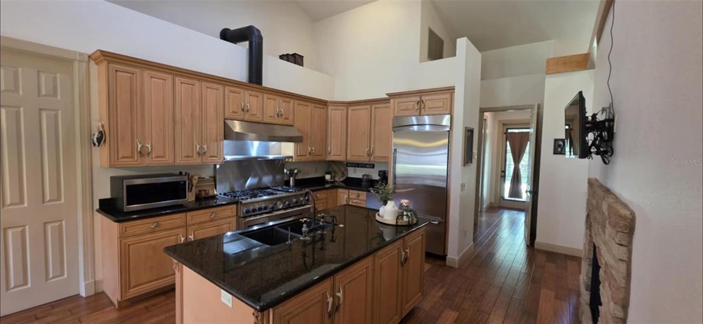 8991 Southwest Springhaven Avenue Indiantown, FL 34956 - Photo 7 of 30 a kitchen with a refrigerator stove and sink