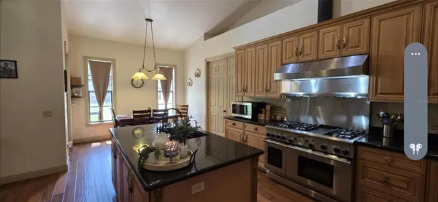 a kitchen with a stove and a wooden floors