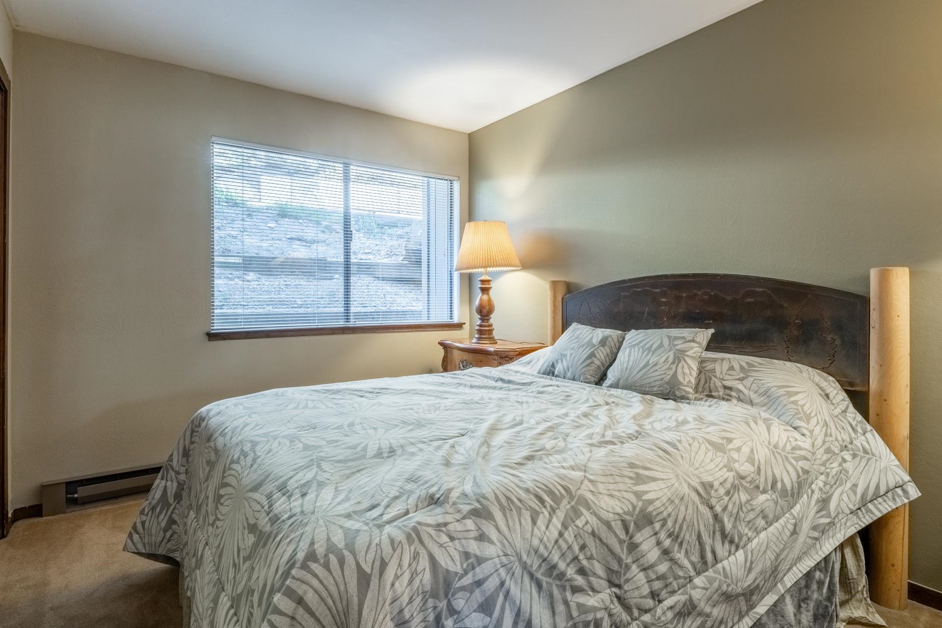 94 John Muir Road, Unit 132 Mammoth Lakes, CA 93546 - Photo 29 of 58 a large bed sitting in a bedroom next to a window