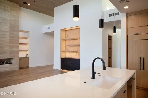 a kitchen that has a sink stainless steel appliances and cabinets
