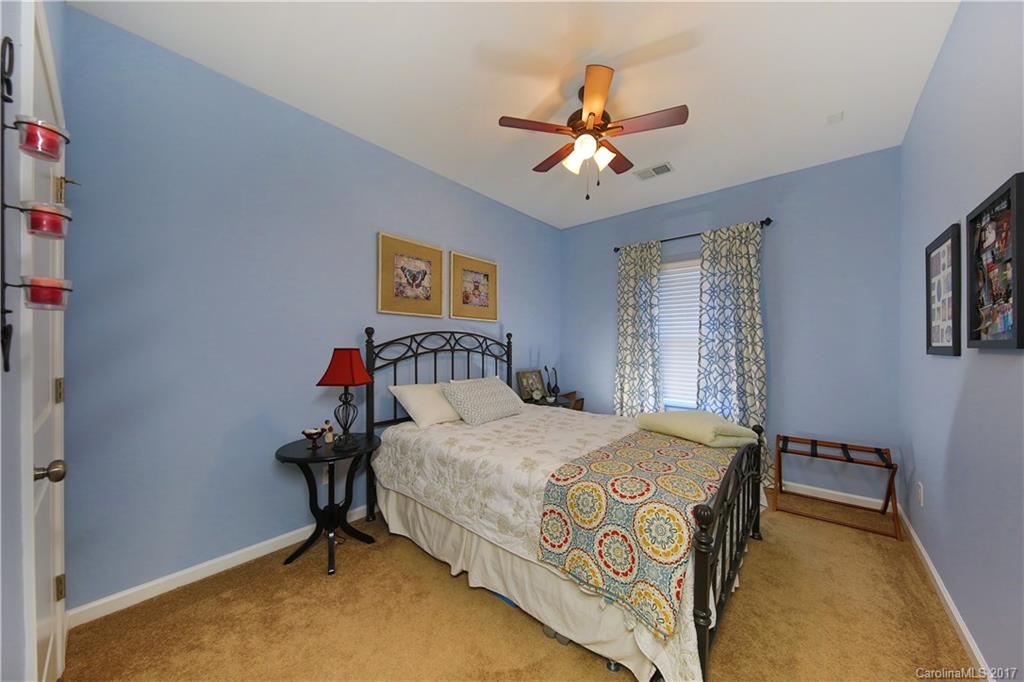 79291 Ridgehaven Road Lancaster, SC 29720 - Photo 13 of 23 a bedroom with a bed and a chandelier