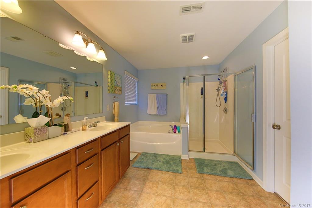 79291 Ridgehaven Road Lancaster, SC 29720 - Photo 16 of 23 a bathroom with a tub a sink and a large mirror
