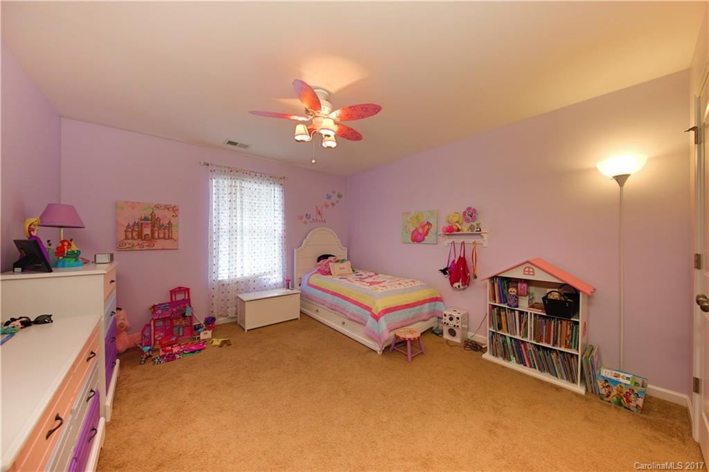 79291 Ridgehaven Road Lancaster, SC 29720 - Photo 17 of 23 a bedroom with furniture and a chandelier