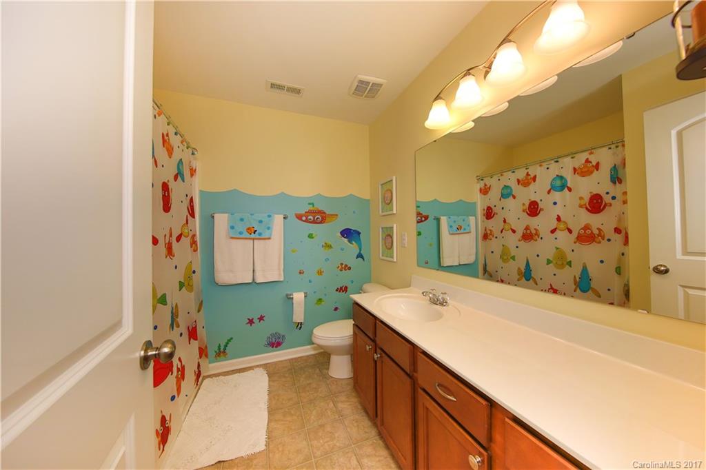 79291 Ridgehaven Road Lancaster, SC 29720 - Photo 19 of 23 a bathroom with a sink mirror and a bathtub