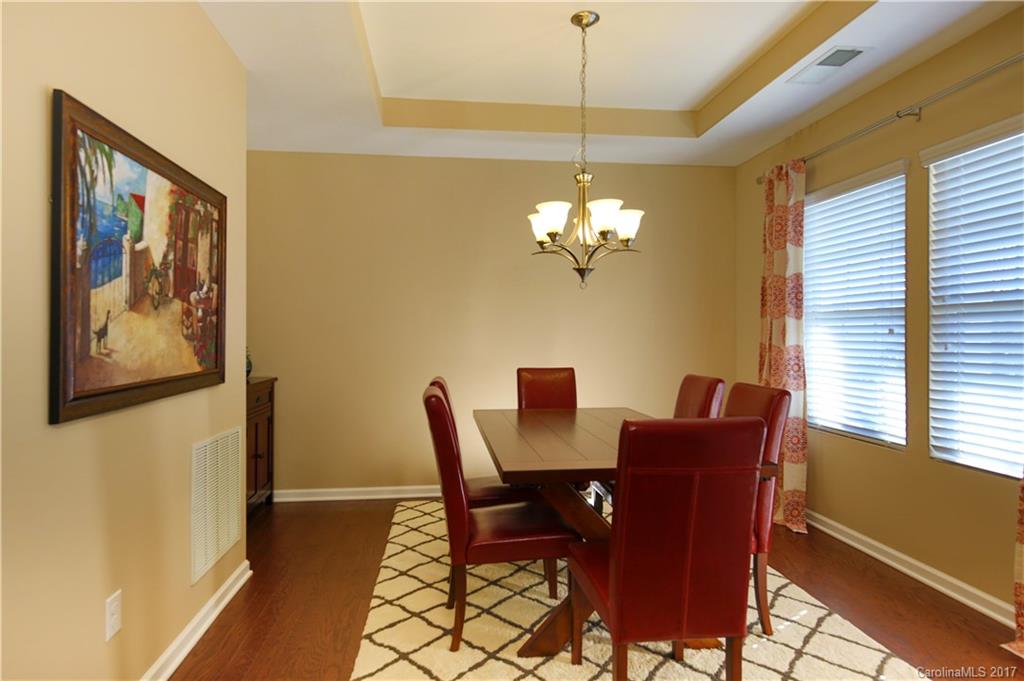 79291 Ridgehaven Road Lancaster, SC 29720 - Photo 3 of 23 a view of a dining room with furniture a chandelier and wooden floor