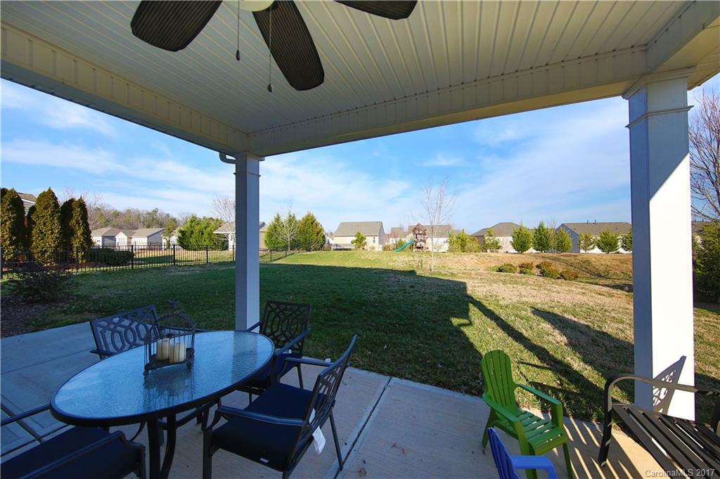 79291 Ridgehaven Road Lancaster, SC 29720 - Photo 23 of 23 a view of a patio with a table chairs and a garden
