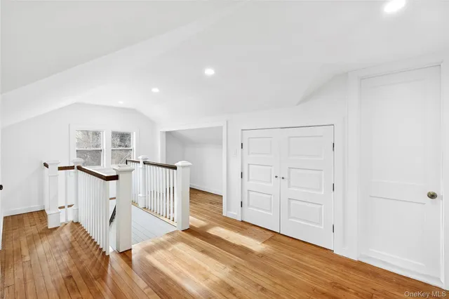a view of a livingroom with wooden floor and entryway
