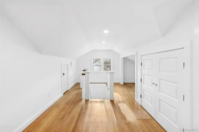 a open kitchen with white cabinets and wooden floor