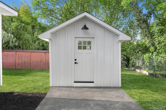 a view of a house with yard and a garden