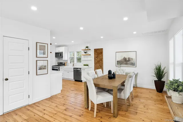 a dining room with furniture and a kitchen view