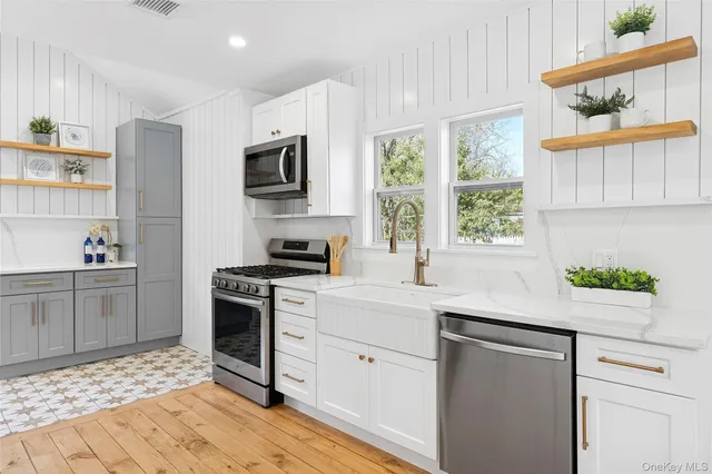 a kitchen with a sink stove and microwave