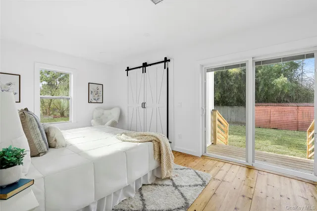 a spacious bedroom with a bed and glass door