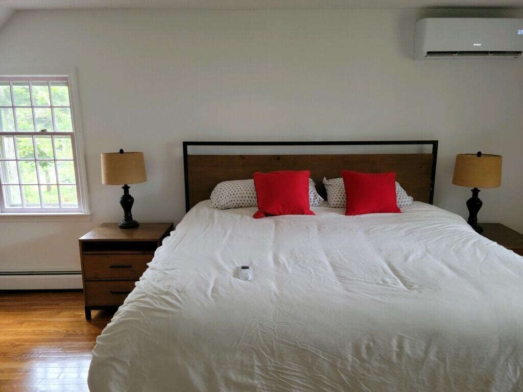 863 Bumps River Road Centerville, MA 02632 - Photo 12 of 22 a bedroom with a large bed and a window