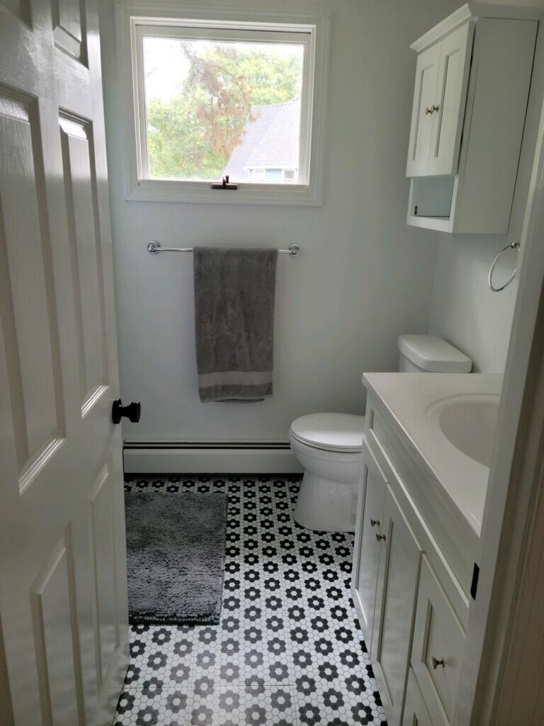 863 Bumps River Road Centerville, MA 02632 - Photo 19 of 22 a bathroom with a sink a toilet a window and a shower
