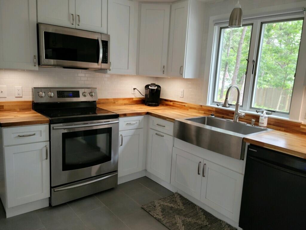 863 Bumps River Road Centerville, MA 02632 - Photo 6 of 22 a kitchen with stainless steel appliances a stove microwave and sink
