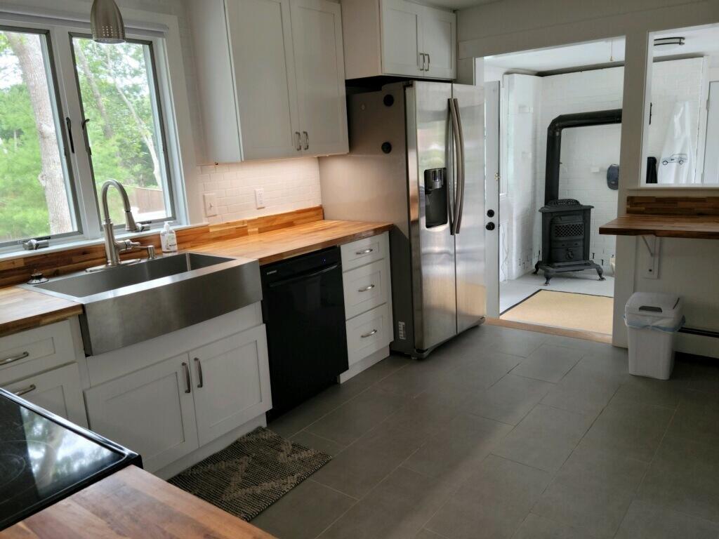 863 Bumps River Road Centerville, MA 02632 - Photo 7 of 22 a kitchen with stainless steel appliances a sink stove and refrigerator