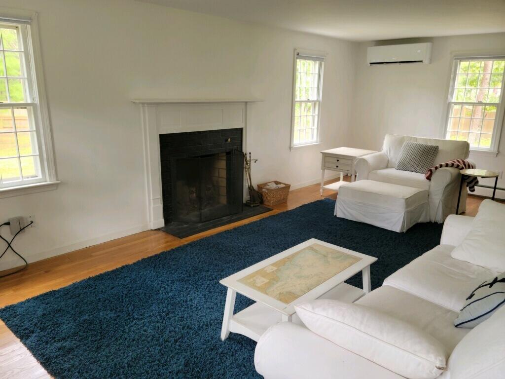863 Bumps River Road Centerville, MA 02632 - Photo 10 of 22 a living room with furniture and a fireplace