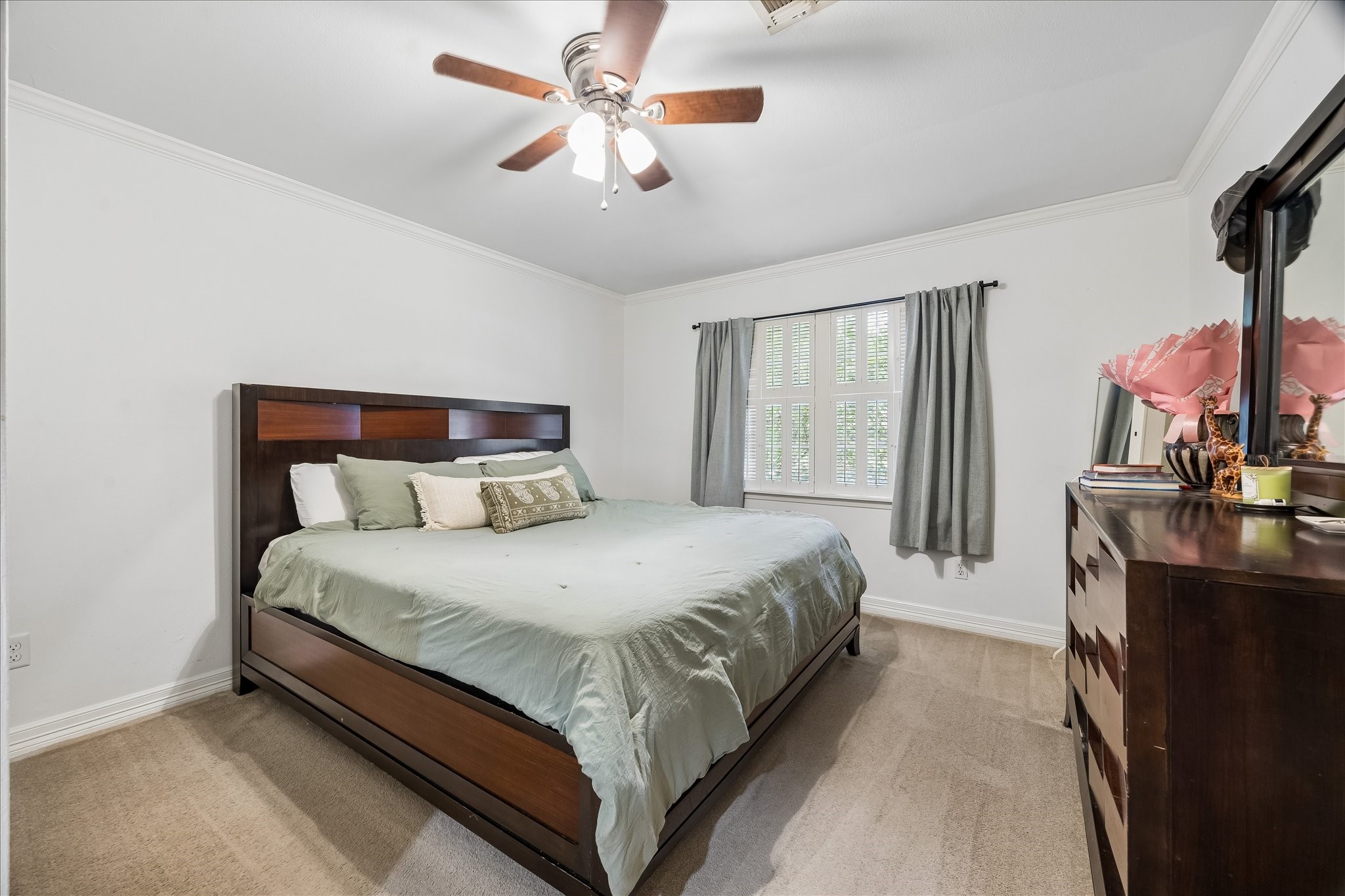 5526 Grape Street Houston, TX 77096 - Photo 4 of 10 a spacious bedroom with a bed and a chandelier