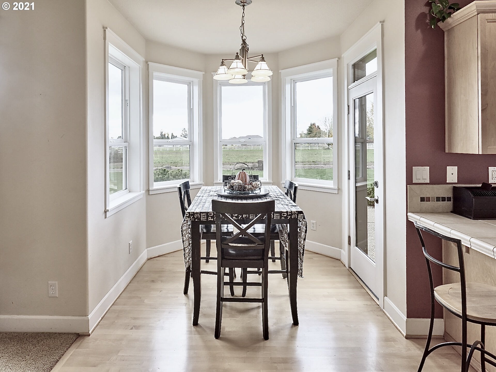 3934 Mission Road Northeast St. Paul, OR 97137 - Photo 12 of 32 a dining room with furniture window wooden floor and a chandelier