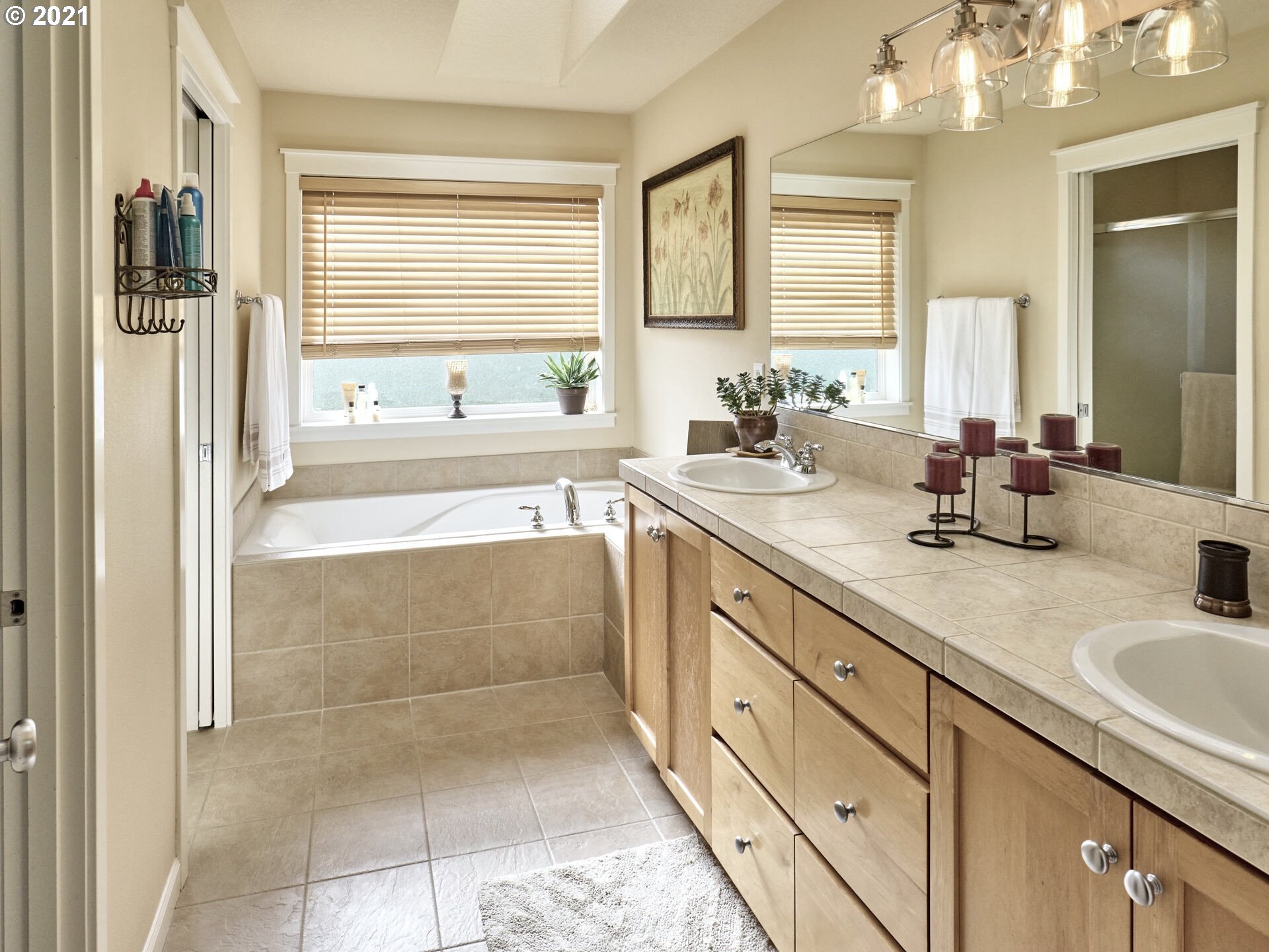 3934 Mission Road Northeast St. Paul, OR 97137 - Photo 15 of 32 a spacious bathroom with a sink a mirror a bathtub and next to a window