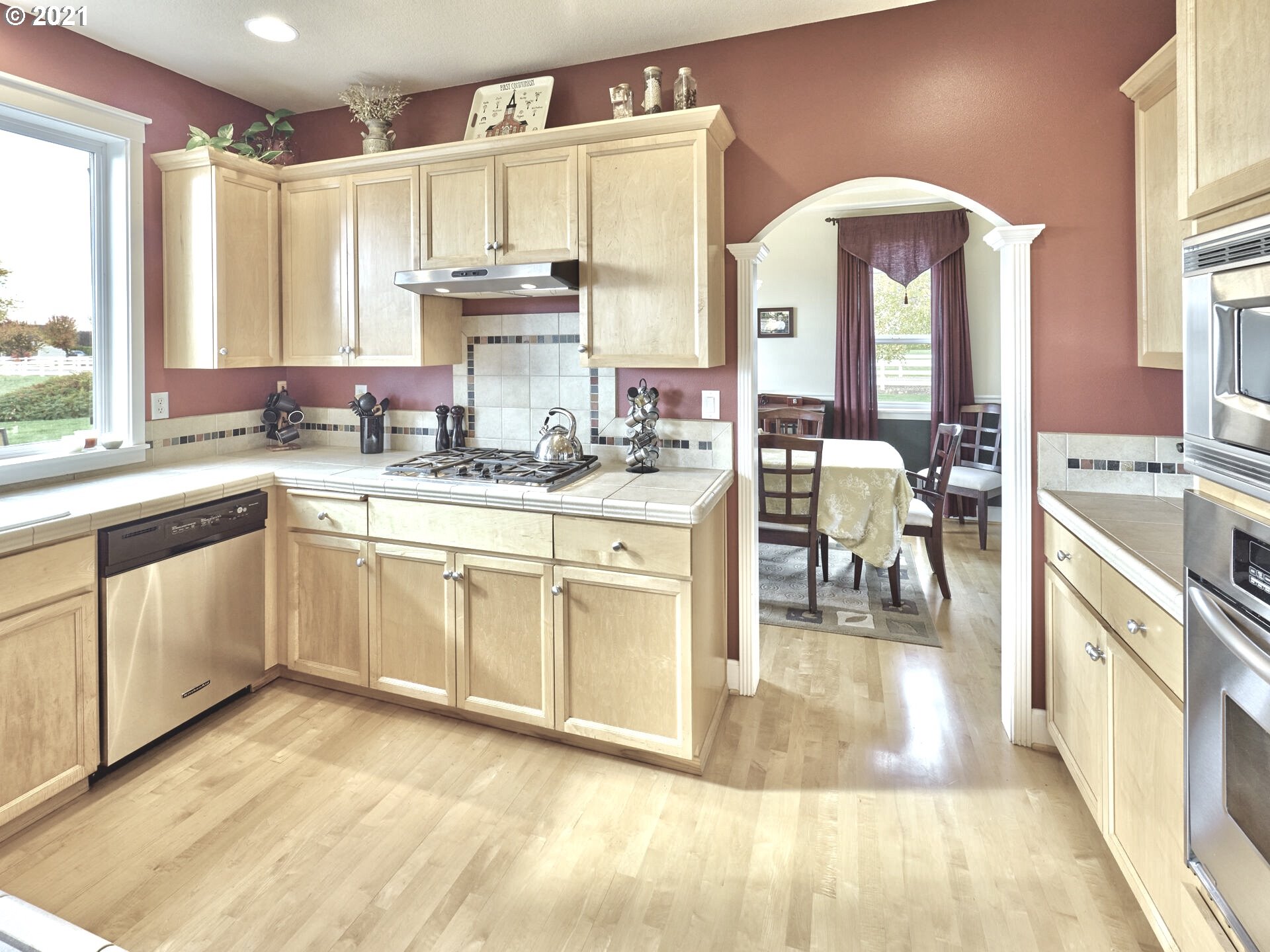3934 Mission Road Northeast St. Paul, OR 97137 - Photo 8 of 32 a large white kitchen with cabinets and outdoor view