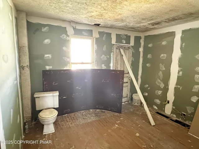 a bathroom with a toilet a sink and a mirror