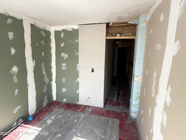 a view of a hallway with entryway and front door