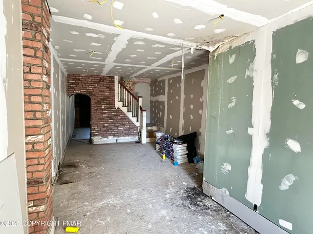 a view of entryway with a front door and wooden floor