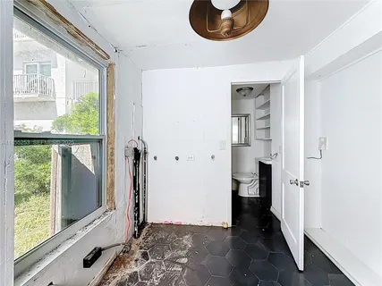 a view of a room with wooden floor and windows