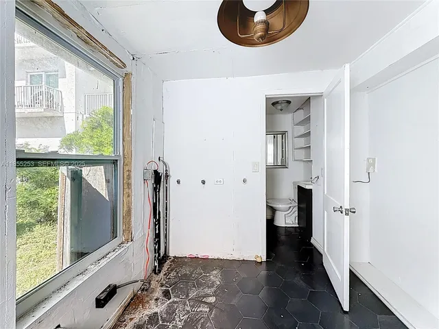 a view of a room with wooden floor and windows