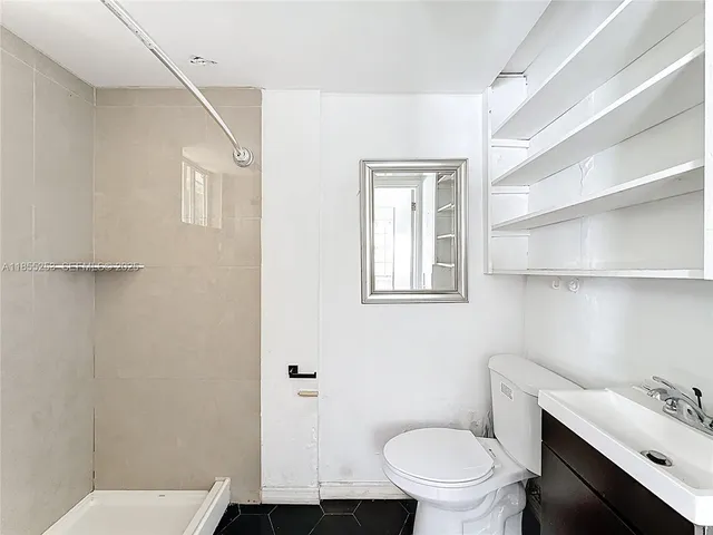 a bathroom with a toilet a sink and bathtub
