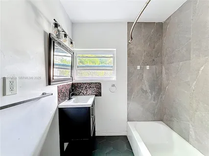 a bathroom with a sink a bathtub and a shower