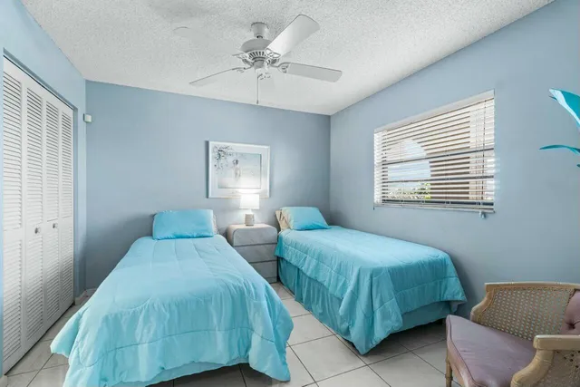 a bedroom with two beds and a chandelier